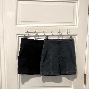 Two free people mini skirts. Both denim. One black, one blue.